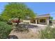 Charming backyard with lush landscaping, a mature shade tree, and mountain views at 16861 N 106Th Way, Scottsdale, AZ 85255