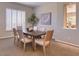 Sophisticated dining area with a large table, modern decor, and neutral color palette at 16861 N 106Th Way, Scottsdale, AZ 85255