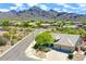 Desert home featuring a 2-car garage and mature landscaping with mountain views at 16861 N 106Th Way, Scottsdale, AZ 85255
