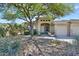 Charming home exterior featuring a beautiful desert landscaped front yard and stone accents at 16861 N 106Th Way, Scottsdale, AZ 85255