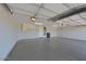 Spacious two-car garage with epoxy flooring, storage cabinets, and a water heater at 16861 N 106Th Way, Scottsdale, AZ 85255