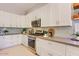 Modern kitchen features white cabinets, stainless steel appliances, and ample counter space at 16861 N 106Th Way, Scottsdale, AZ 85255