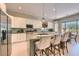 Modern kitchen with island, white cabinetry, stainless steel appliances and pendant lighting fixtures at 16861 N 106Th Way, Scottsdale, AZ 85255