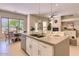 Stylish kitchen island with barstool seating and a view of the dining and living areas at 16861 N 106Th Way, Scottsdale, AZ 85255