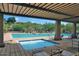 Community swimming pool featuring different depth areas, lounge chairs, and shaded seating at 16861 N 106Th Way, Scottsdale, AZ 85255