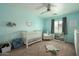 Charming Bedroom with a crib, soft blue walls, and coordinated decor for a peaceful haven at 17613 N 114Th Ln, Surprise, AZ 85378