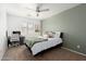 Inviting bedroom featuring a modern ceiling fan, neutral carpet, and a serene accent wall at 17613 N 114Th Ln, Surprise, AZ 85378