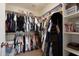 Organized walk-in closet with shelving and hanging rods maximizes storage and keeps belongings tidy at 17613 N 114Th Ln, Surprise, AZ 85378