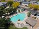Aerial view of a community pool area with lounge chairs and well maintained landscaping at 17613 N 114Th Ln, Surprise, AZ 85378