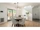 Cozy dining area with modern light fixture and sliding door at 17613 N 114Th Ln, Surprise, AZ 85378