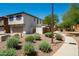 Exterior view of a two-story home with an attached garage, desert landscaping, and a sidewalk at 17613 N 114Th Ln, Surprise, AZ 85378