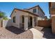 Charming home with a covered front porch, desert landscape, and a walkway at 17613 N 114Th Ln, Surprise, AZ 85378
