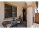 Inviting front porch featuring stylish outdoor furniture and tasteful decor creating a warm welcome at 17613 N 114Th Ln, Surprise, AZ 85378