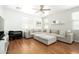 Bright living room featuring a large sectional sofa, wood floors, and a ceiling fan at 17613 N 114Th Ln, Surprise, AZ 85378
