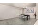 Elegant dining area with neutral carpet, a chandelier, and seating for four at a dark wood table at 18622 N 28Th Way, Phoenix, AZ 85050