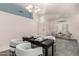 Bright dining room with modern chandelier, table set for four, and cozy seating area at 18622 N 28Th Way, Phoenix, AZ 85050