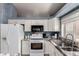 Close-up of the kitchen with white appliances, cabinets and granite countertops at 18622 N 28Th Way, Phoenix, AZ 85050