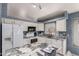 Bright kitchen featuring white cabinets, granite countertops, stainless steel appliances, and a breakfast bar at 18622 N 28Th Way, Phoenix, AZ 85050