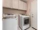 Well-equipped laundry room area with tile flooring and side by side washer and dryer at 18622 N 28Th Way, Phoenix, AZ 85050