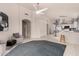 Open-concept living area with tile floors, neutral furniture, and a view of the kitchen at 18622 N 28Th Way, Phoenix, AZ 85050