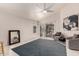 Spacious living room with tile flooring, a modern ceiling fan, and sliding glass doors to the outside at 18622 N 28Th Way, Phoenix, AZ 85050