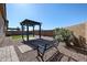 Serene backyard featuring a pergola, artificial grass, and easy-to-maintain gravel landscaping at 1871 E Lantana Dr, Chandler, AZ 85286