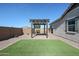 View of artificial turf and pergola in the spacious backyard of the home at 1871 E Lantana Dr, Chandler, AZ 85286