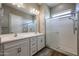 Bathroom featuring double sinks, white cabinetry, and shower at 1871 E Lantana Dr, Chandler, AZ 85286