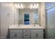 Bathroom featuring double sinks, white cabinetry, and walk in shower at 1871 E Lantana Dr, Chandler, AZ 85286