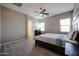 Cozy bedroom with neutral walls, carpet, and a ceiling fan; perfect for relaxation at 1871 E Lantana Dr, Chandler, AZ 85286