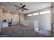Upstairs bonus room featuring carpeted floors, a ceiling fan, and three windows offering natural light at 1871 E Lantana Dr, Chandler, AZ 85286