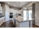 Bright kitchen features a stone countertop island, stainless steel appliances, and backyard view at 1871 E Lantana Dr, Chandler, AZ 85286