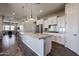 The kitchen features stainless steel appliances, a stone countertop island, and ample cabinet space at 1871 E Lantana Dr, Chandler, AZ 85286