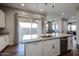 Modern kitchen features granite countertops, stainless steel appliances and a center island perfect for entertaining at 1871 E Lantana Dr, Chandler, AZ 85286