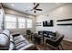 A stylish living room features a brown leather sofa, modern decor, and a ceiling fan at 1871 E Lantana Dr, Chandler, AZ 85286