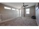 Bright loft area with neutral walls, carpet, white railing, a ceiling fan, and natural light at 1871 E Lantana Dr, Chandler, AZ 85286