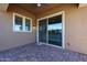 View of covered patio with brick flooring and sliding glass doors leading to outdoor living area at 1871 E Lantana Dr, Chandler, AZ 85286