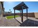 View of pergola with stone flooring, turf and gravel in spacious backyard at 1871 E Lantana Dr, Chandler, AZ 85286