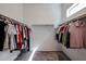 Spacious walk-in closet with ample storage space and natural light from a high window at 1871 E Lantana Dr, Chandler, AZ 85286