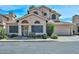 Attractive two-story home featuring desert landscaping, a 2-car garage, and multiple arched windows at 18807 N 42Nd Ave, Glendale, AZ 85308