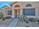 Inviting front entrance of a charming home featuring desert landscaping and an arched window at 18807 N 42Nd Ave, Glendale, AZ 85308