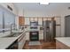 Kitchen featuring stainless steel appliances, laminate countertops, wood-style flooring, and natural light at 18807 N 42Nd Ave, Glendale, AZ 85308