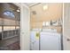 Bright laundry room with washer, dryer, and storage space at 18807 N 42Nd Ave, Glendale, AZ 85308