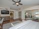 Large main bedroom featuring a ceiling fan, hardwood floors, access to ensuite bath, and sliding mirrored closet doors at 18807 N 42Nd Ave, Glendale, AZ 85308