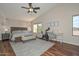 The main bedroom features a ceiling fan, wood floors, and lots of natural light at 18807 N 42Nd Ave, Glendale, AZ 85308