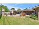 Expansive backyard with a brick patio, lush lawn, and comfortable seating areas at 2013 E Solano Dr, Phoenix, AZ 85016
