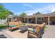 Inviting backyard oasis with brick patio, comfortable seating, and manicured landscaping at 2013 E Solano Dr, Phoenix, AZ 85016