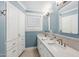Bright bathroom with double sinks, marble counters, custom cabinets and designer fixtures at 2013 E Solano Dr, Phoenix, AZ 85016