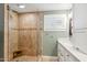 Elegant bathroom with glass-enclosed shower, and pristine white vanity with marble countertop at 2013 E Solano Dr, Phoenix, AZ 85016