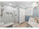 Full bath featuring a walk-in shower and double sink vanity with custom cabinetry at 2013 E Solano Dr, Phoenix, AZ 85016